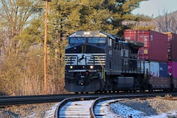 A long freight train moving efficiently along its tracks