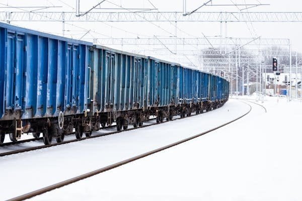 A train moving through a snowy, frozen landscape
