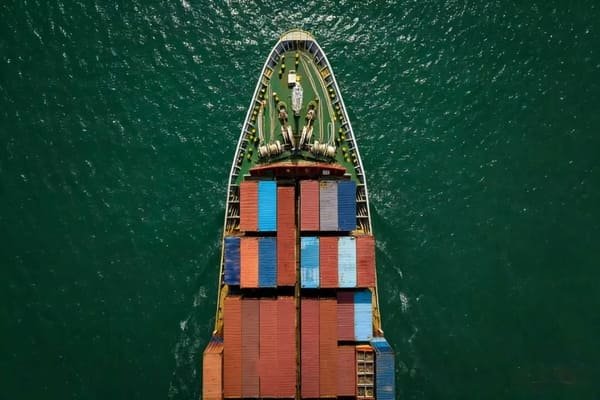 An ISO tank container being loaded onto a truck