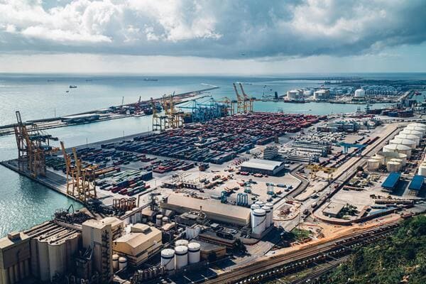 An aerial view of a busy seaport with customs inspection areas.
