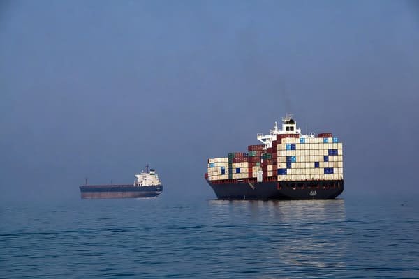 A container ship navigating a narrow strait, representing fertilizer logistics