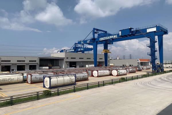A designated hazardous materials storage area in a port, with safety signs