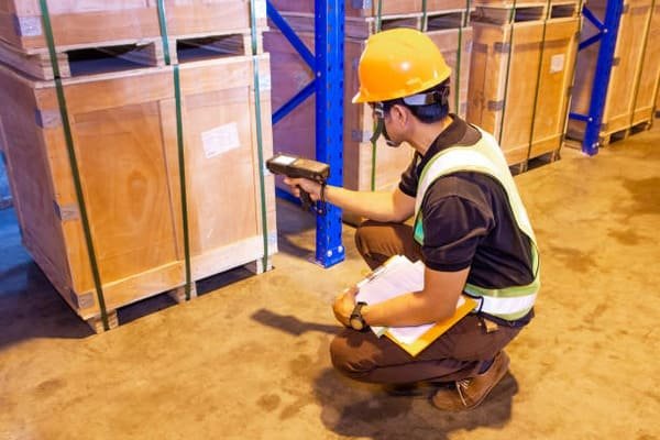 A customs officer inspecting a shipment of electronic devices