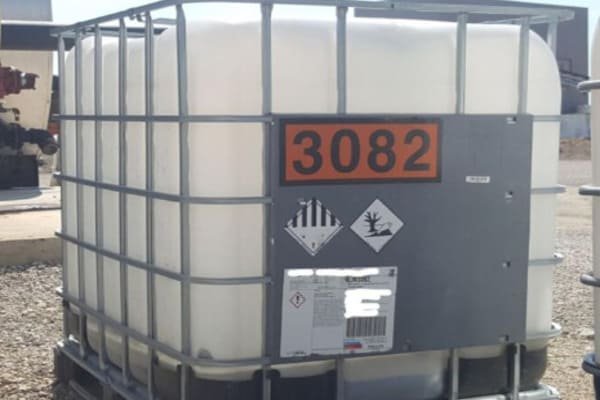 A close-up of a hazard label on a plastic IBC