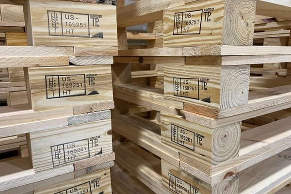 A close-up of a compliant IPPC branded mark on a wooden pallet