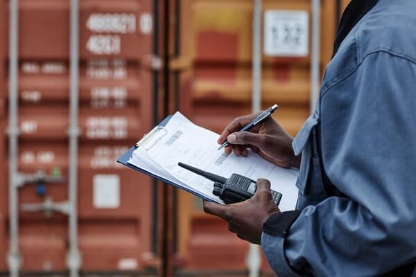 Customs officer inspecting shipping documents