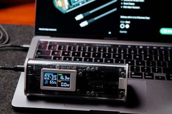 A picture showing a standalone power bank next to a laptop computer.