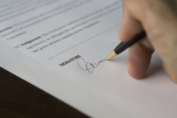A checklist and pen next to a shipping document