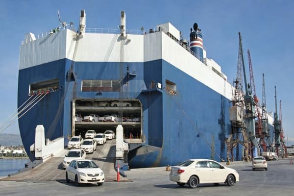 Vehicle being secured inside a shipping container with ratchet straps