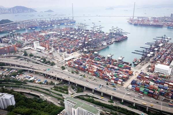 A container ship docked at a busy South American port