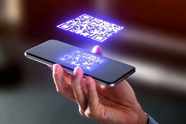 A smartphone scanning a QR code on a battery.