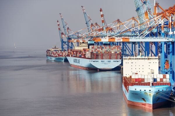 A large, modern container terminal with many ships, representing Port Klang