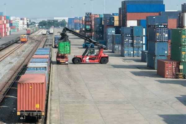 A logistics worker inspecting a packed container with a checklist
