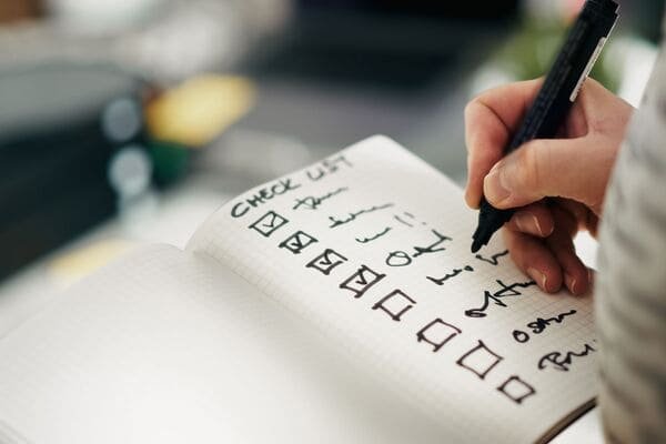 Person checking off items on a checklist