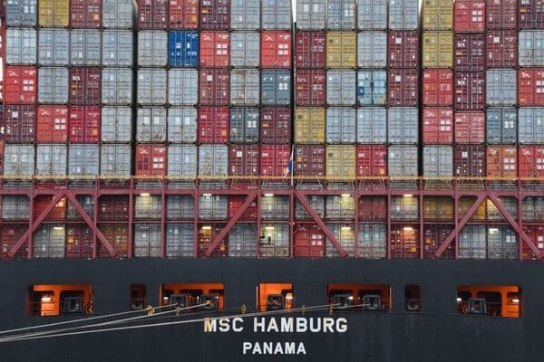 Container ship moving from China to Malaysia on a map