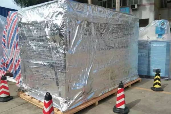 A worker placing desiccants inside a shipping container