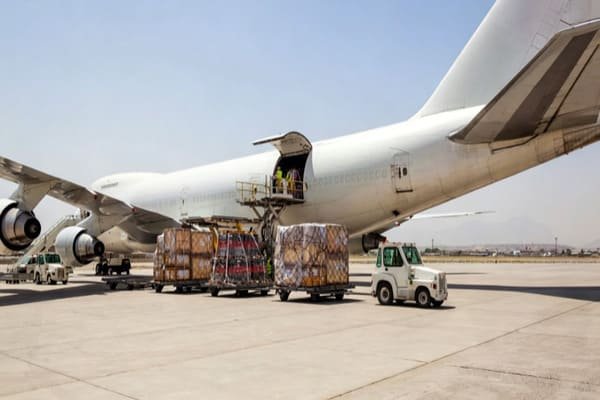 An assortment of large cargo being loaded onto an airplane