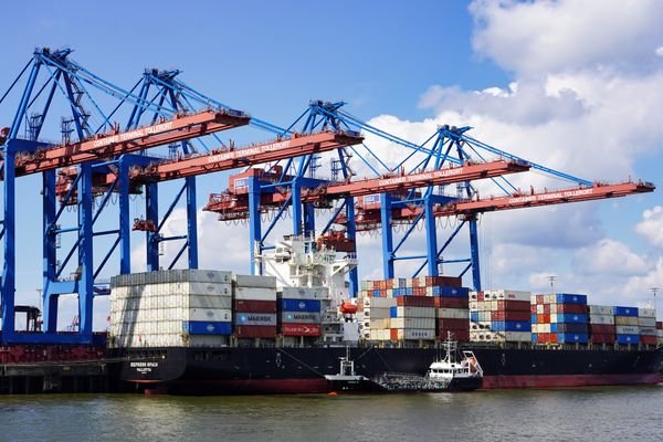 A container ship at a port, representing international trade and Incoterms