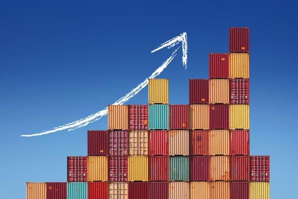 Container ships stacked at a busy port